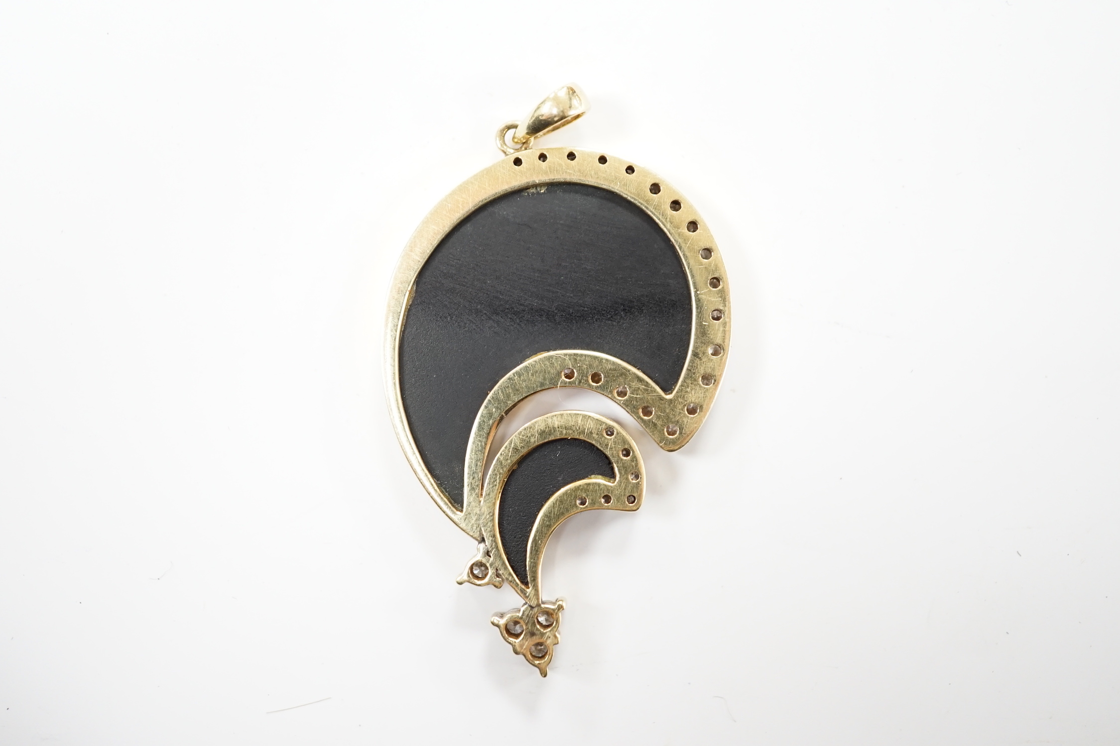 A Hong Kong 585 yellow metal, black onyx and diamond set stylised pendant, 43mm, gross weight 12.1 grams.